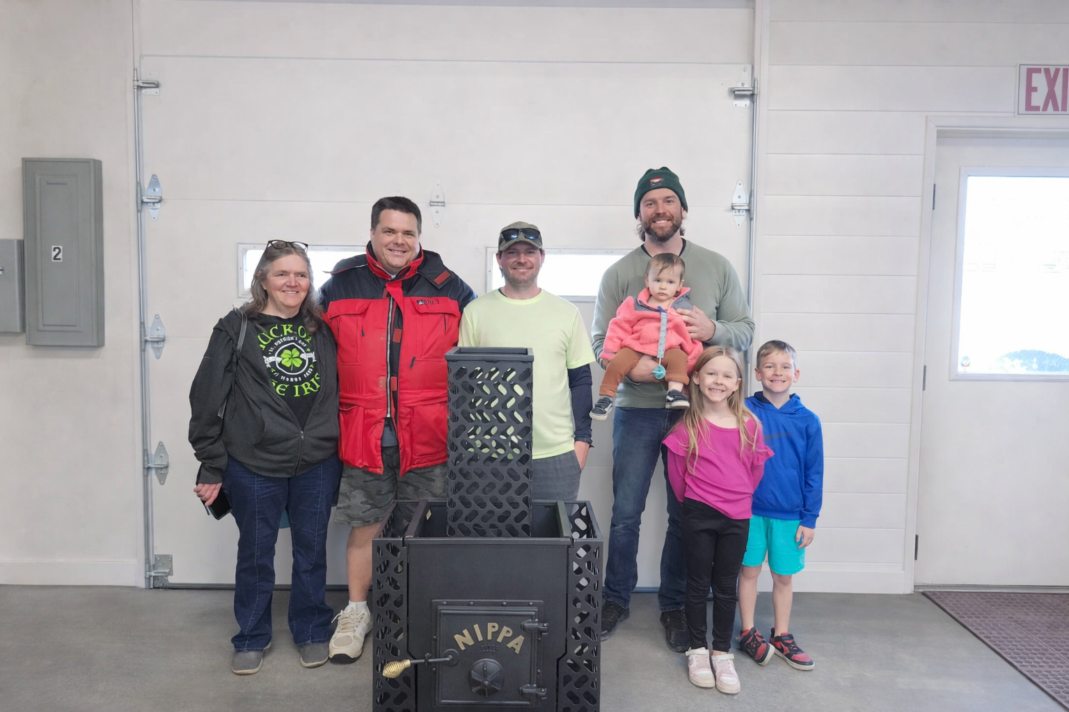 Nippa family members Cynthia Krueger, Paul Krueger, and Scott Krueger visiting new owner Philip Casteleyn and his family at the Nippa Sauna Stove facility in Beulah Michigan
